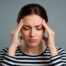 The girl is stressed and holding her head