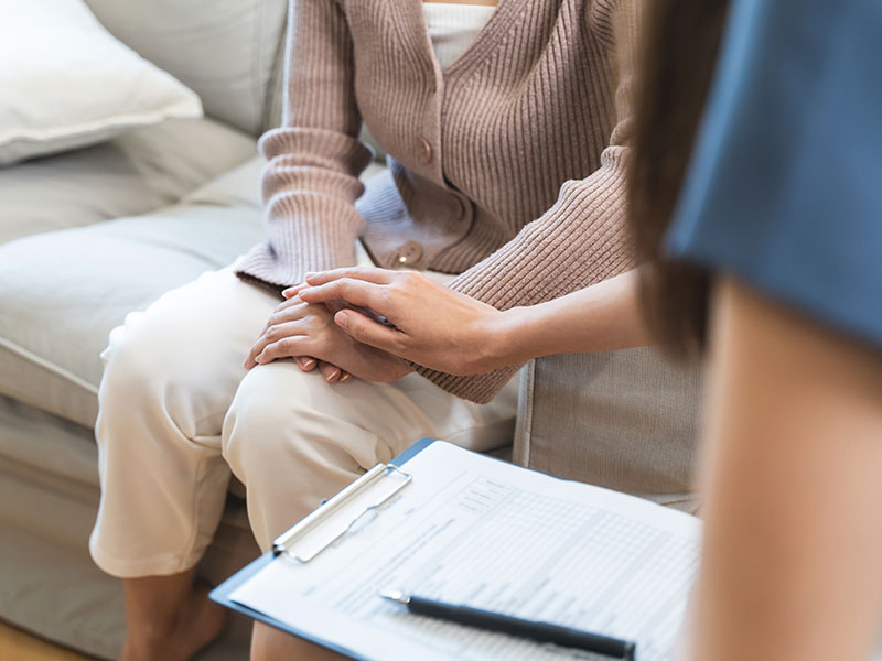 The doctor holds the patient's hand