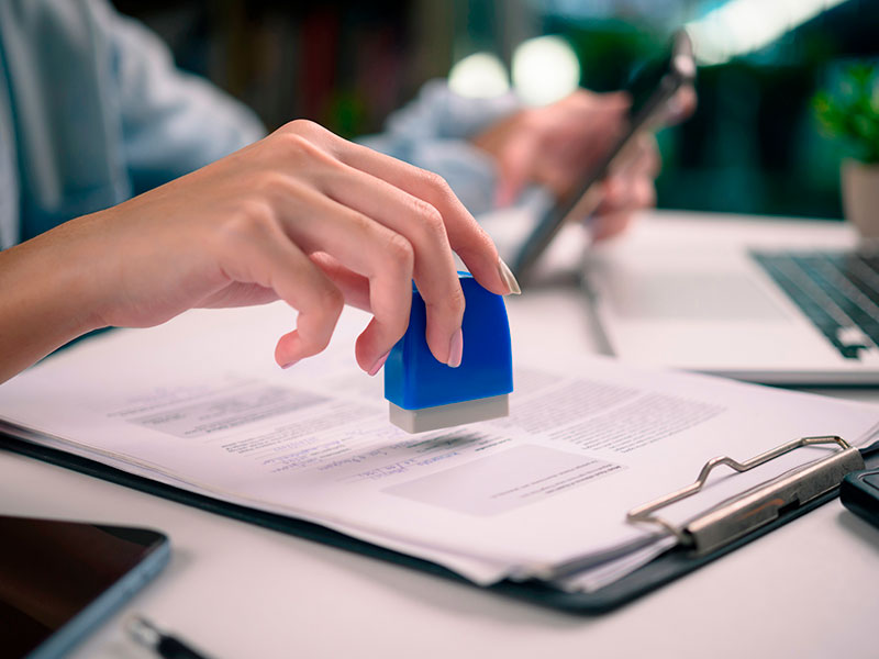 An employee of the rehabilitation center fills out the documents and stamps them
