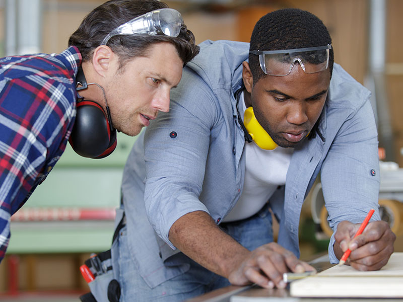 Rebuilding-Life-After-Rehab-2 Two men are puzzled by the work
