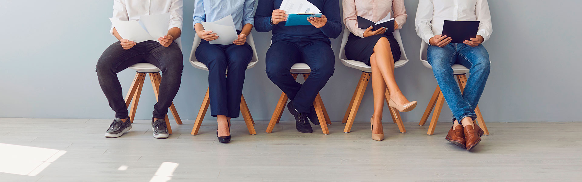 People are sitting in line waiting for a job interview