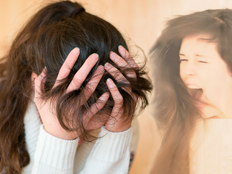 The girl is holding her head and inside she is worried