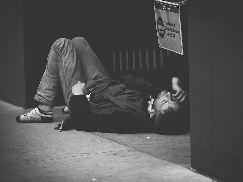 Why-So-Many-People-Hide-their-Addiction-from-Family-3 A man with drug addiction is lying on the asphalt